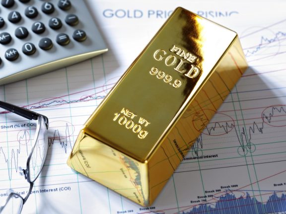 Gold bullion barr on a stocks and shares chart