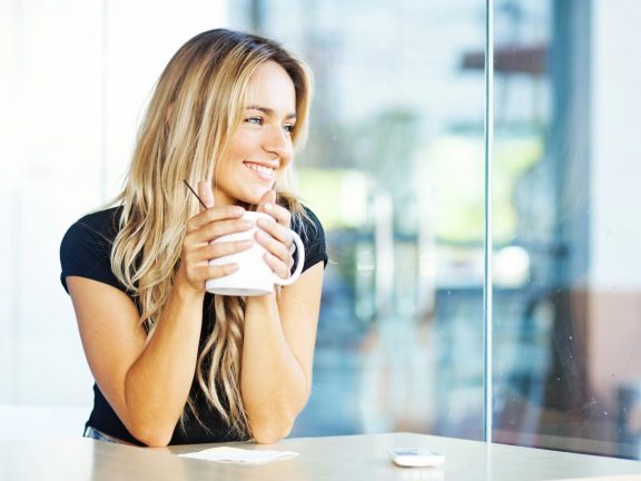 Woman drinking coffee in the morning at restaurant