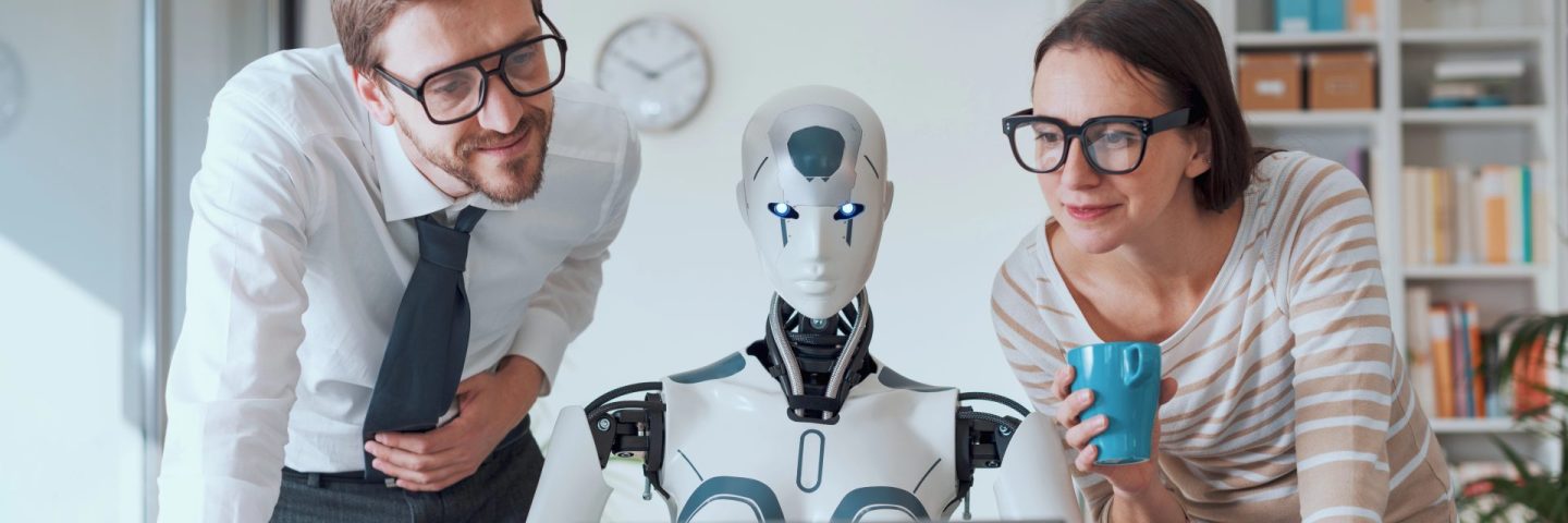Happy business people supervising an AI robot working in the office