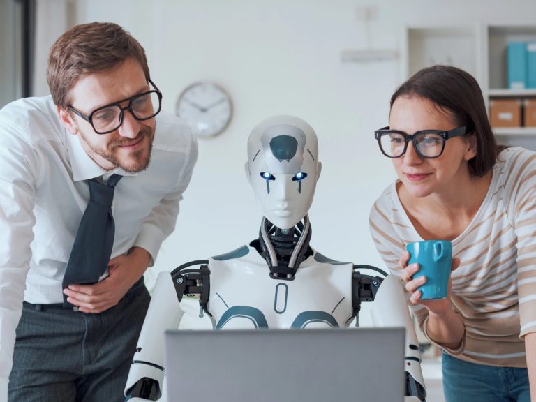 Happy business people supervising an AI robot working in the office
