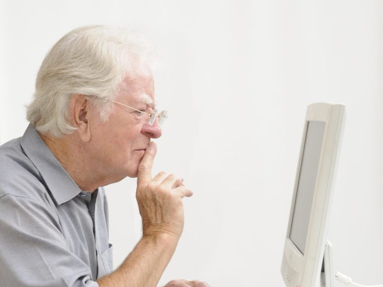 senior man working on computer at home