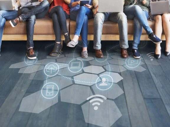 people sit with devices and icons